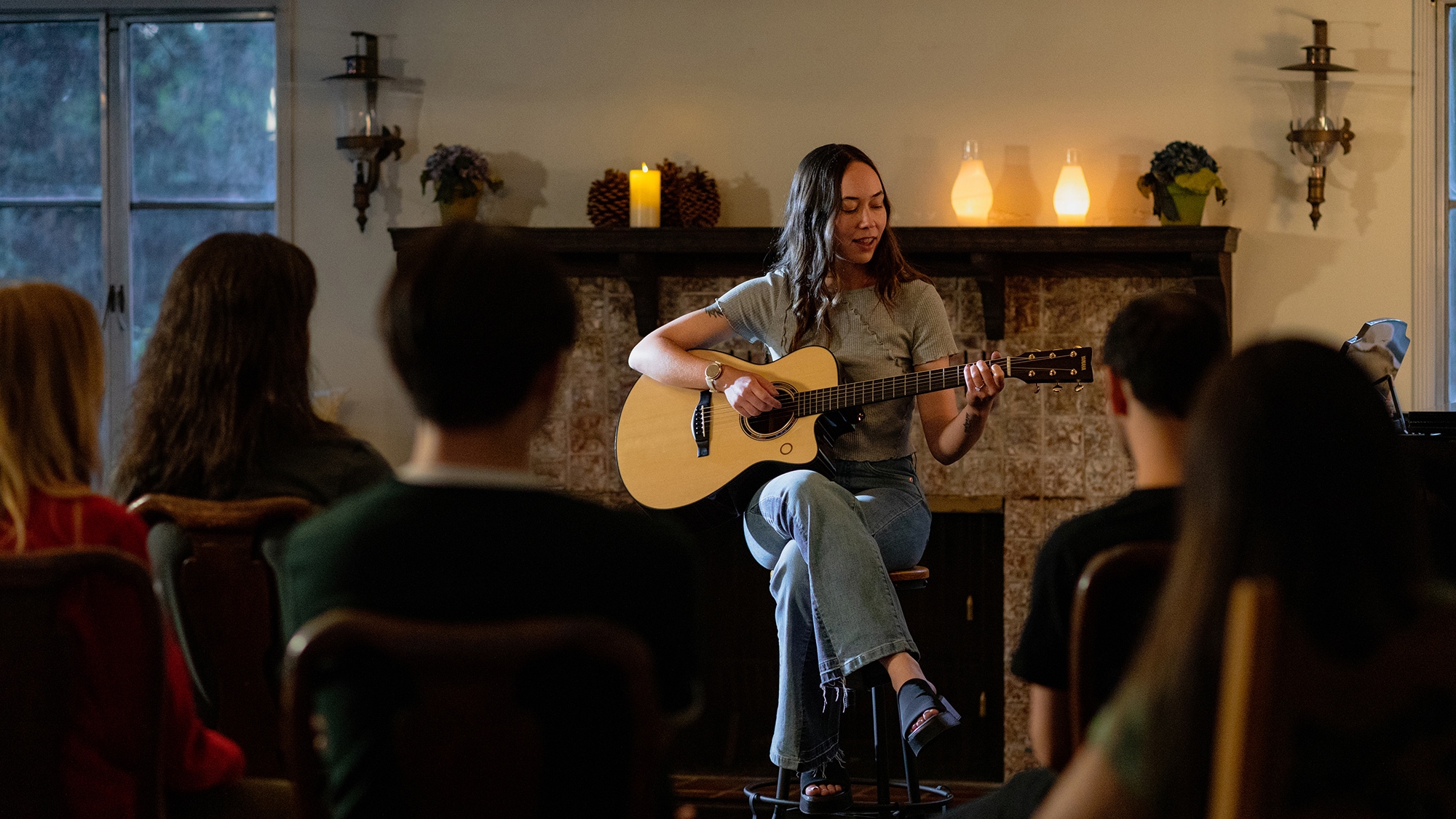 Musician performing in front of an audience with the TAS3 C acoustic guitar.