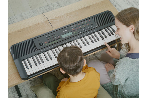 Parent and child happily playing the YPT-280 side by side