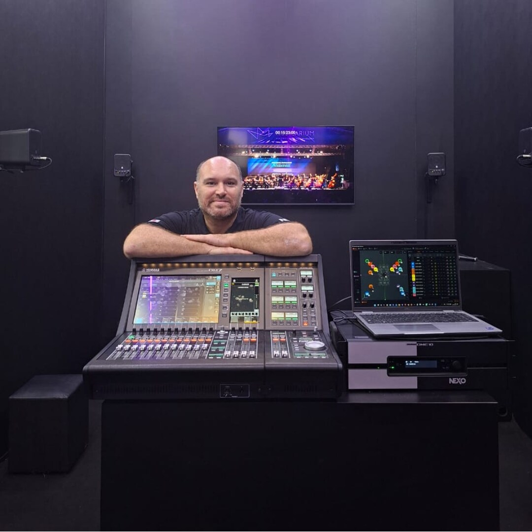 Yamaha MGX16V mixer positioned at front of house with microphone and performance playlist visible.