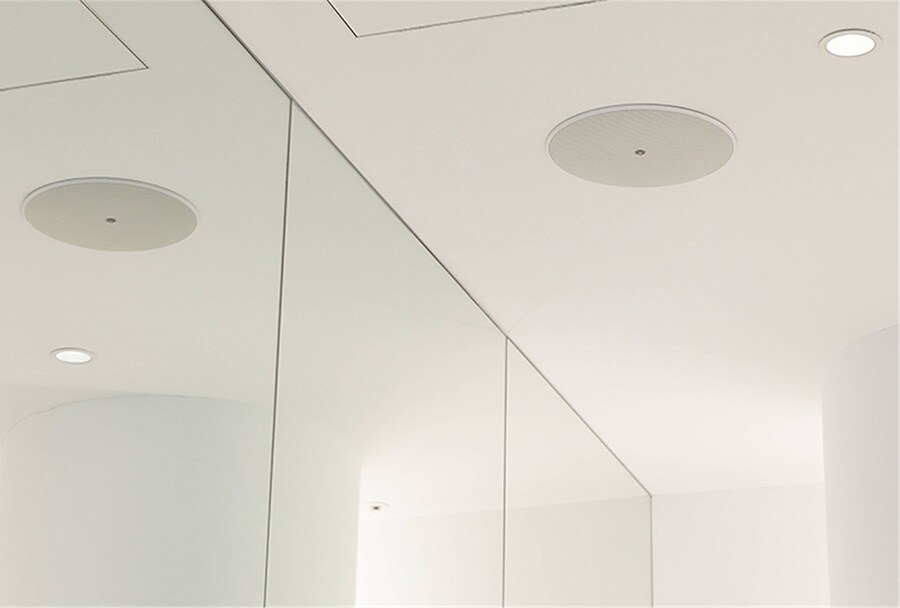 An in-ceiling speaker seamlessly installed for high-quality sound distribution.